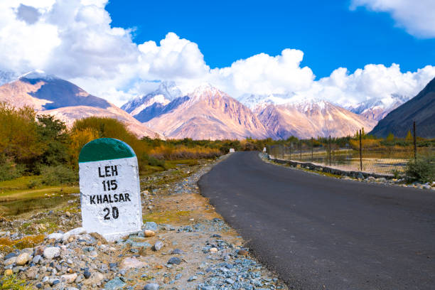 indian style milestone beside the road to nubra valley, ladakh, india.